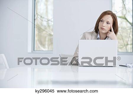 Businesswoman working on a laptop View Large Photo Image Stock Photography - Businesswoman working on a laptop. Fotosearch