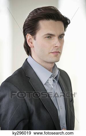 Stock Photo - Close-up of a businessman looking serious. Fotosearch
