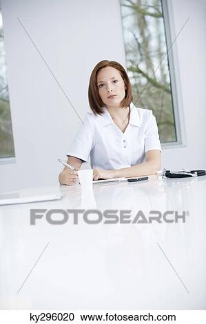 Female doctor working in an office View Large Photo Image Stock Image - Female doctor working in an office. Fotosearch