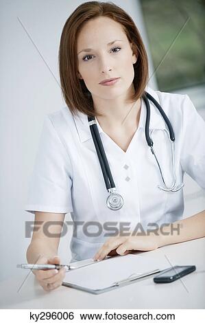 Female doctor working in an office View Large Photo Image Stock Photograph - Female doctor working in an office. Fotosearch