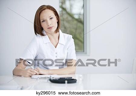 Stock Photography - Female doctor working in an office. Fotosearch