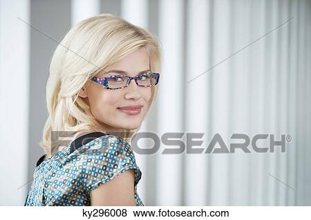 Portrait of a woman wearing eyeglasses and smiling View Large Photo Image Stock Photo - Portrait of a woman wearing eyeglasses and smiling. Fotosearch