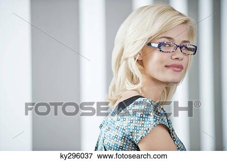 Portrait of a woman wearing eyeglasses and smiling View Large Photo Image Stock Photo - Portrait of a woman wearing eyeglasses and smiling. Fotosearch