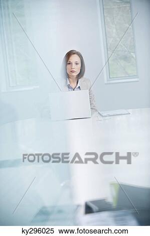 Woman working on a laptop View Large Photo Image Stock Photography - Woman working on a laptop. Fotosearch