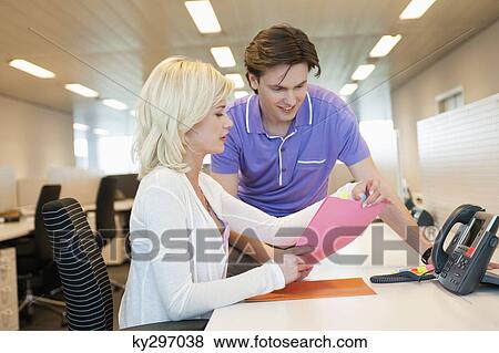 Business executives discussing a document View Large Photo Image Stock Photo - Business executives discussing a document. Fotosearch
