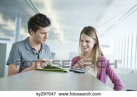 Business executives doing paperwork in an office View Large Photo Image Stock Photo - Business executives doing paperwork in an office. Fotosearch
