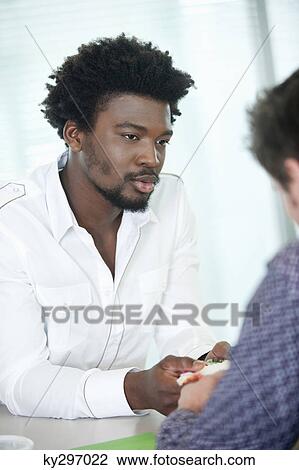 Businessmen discussing in an office View Large Photo Image Stock Image - Businessmen discussing in an office. Fotosearch