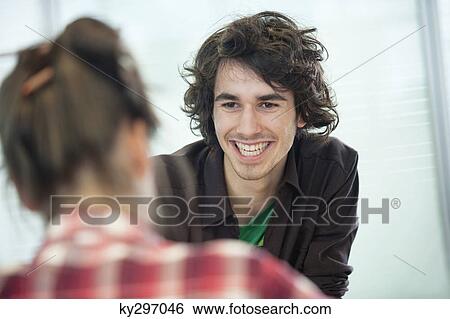 Businessmen smiling in an office View Large Photo Image Stock Photograph - Businessmen smiling in an office. Fotosearch