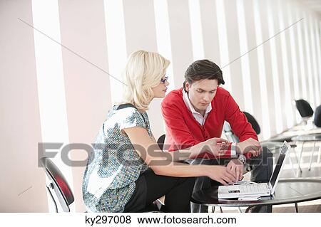 Couple using a laptop View Large Photo Image Stock Photo - Couple using a laptop. Fotosearch