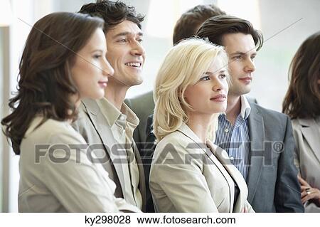 Stock Photo - Business executives standing together. Fotosearch
