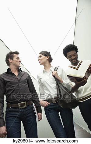 Business executives walking in the corridor of an office View Large Photo Image Picture - Business executives walking in the corridor of an office. Fotosearch