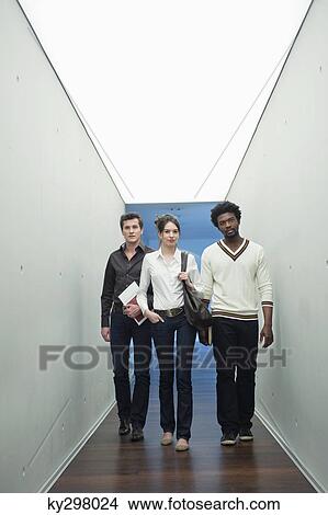 Business executives walking in the corridor of an office View Large Photo Image Picture - Business executives walking in the corridor of an office. Fotosearch