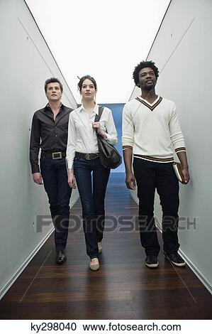Business executives walking in the corridor of an office View Large Photo Image Stock Image - Business executives walking in the corridor of an office. Fotosearch