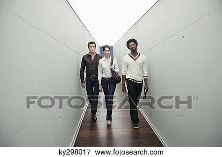 Business executives walking in the corridor of an office View Large Photo Image Stock Photo - Business executives walking in the corridor of an office. Fotosearch