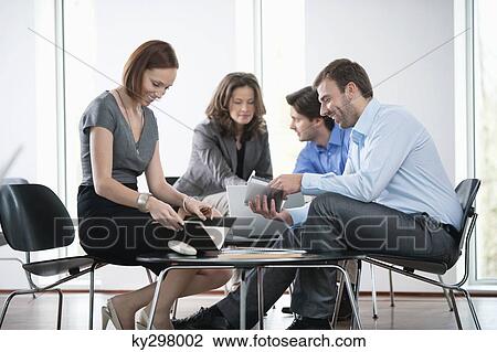 Business executives working in an office View Large Photo Image Stock Image - Business executives working in an office. Fotosearch