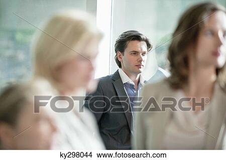 Businessman standing in an office View Large Photo Image Picture - Businessman standing in an office. Fotosearch