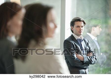 Businessman standing with his arms crossed View Large Photo Image Stock Image - Businessman standing with his arms crossed. Fotosearch
