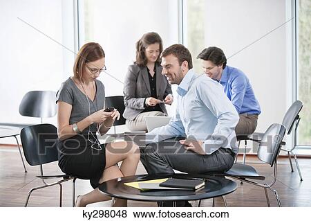 Businesswoman listening to an MP3 player View Large Photo Image Stock Photo - Businesswoman listening to an MP3 player. Fotosearch