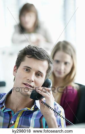 Portrait of a businessman talking on a telephone View Large Photo Image Stock Photo - Portrait of a businessman talking on a telephone. Fotosearch