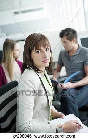 Portrait of a businesswoman doing paperwork View Large Photo Image Stock Photograph - Portrait of a businesswoman doing paperwork. Fotosearch