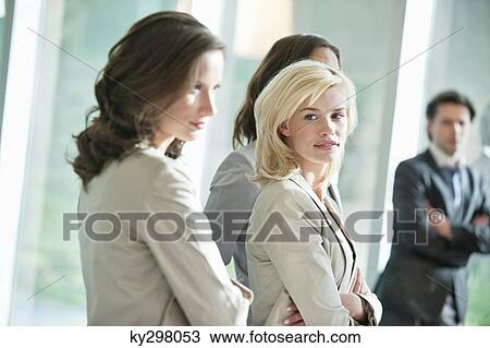 Portrait of a businesswoman standing with her colleague View Large Photo Image Stock Image - Portrait of a businesswoman standing with her colleague. Fotosearch