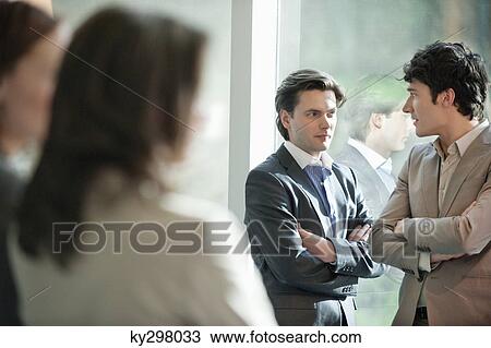 Two businessmen discussing each other View Large Photo Image Stock Image - Two businessmen discussing each other. Fotosearch