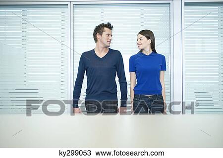 Business couple romancing in an office View Large Photo Image Stock Image - Business couple romancing in an office. Fotosearch