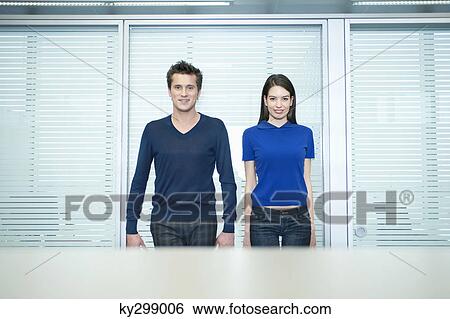 Business executives standing in an office View Large Photo Image Stock Photograph - Business executives standing in an office. Fotosearch