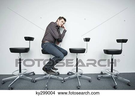 Picture - Businessman sitting on a chair and thinking. Fotosearch