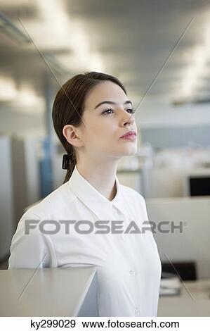 Businesswoman standing in an office View Large Photo Image Stock Photo - Businesswoman standing in an office. Fotosearch