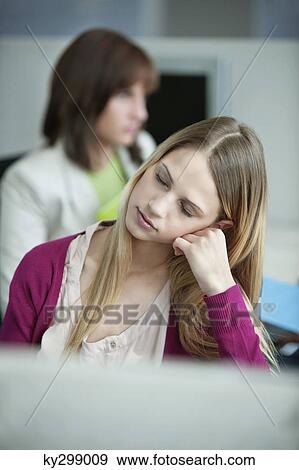 Businesswomen resting in an office View Large Photo Image Stock Photo - Businesswomen resting in an office. Fotosearch