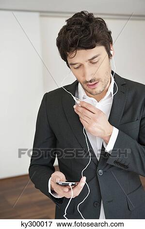 Businessman talking on a mobile phone View Large Photo Image Stock Photo - Businessman talking on a mobile phone. Fotosearch