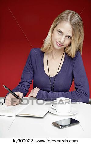 Businesswoman working in an office View Large Photo Image Stock Image - Businesswoman working in an office. Fotosearch