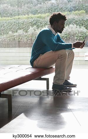 Man text messaging on a mobile phone View Large Photo Image Picture - Man text messaging on a mobile phone. Fotosearch