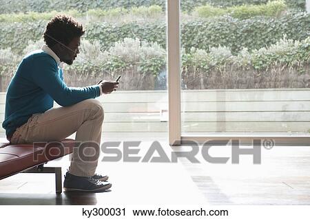Man text messaging on a mobile phone View Large Photo Image Stock Image - Man text messaging on a mobile phone. Fotosearch