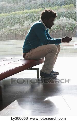 Man text messaging on a mobile phone View Large Photo Image Stock Photograph - Man text messaging on a mobile phone. Fotosearch