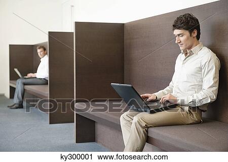 Two businessmen working in an office View Large Photo Image Stock Image - Two businessmen working in an office. Fotosearch