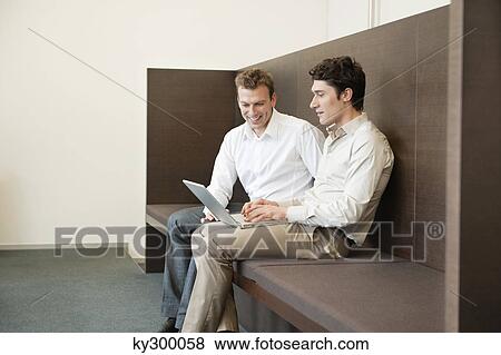 Two businessmen working in an office View Large Photo Image Stock Photo - Two businessmen working in an office. Fotosearch