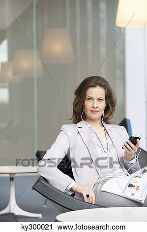 Woman listening to an MP3 player View Large Photo Image Stock Image - Woman listening to an MP3 player. Fotosearch