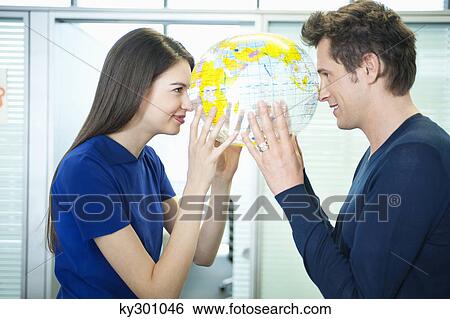 Business couple romancing in an office View Large Photo Image Stock Photograph - Business couple romancing in an office. Fotosearch
