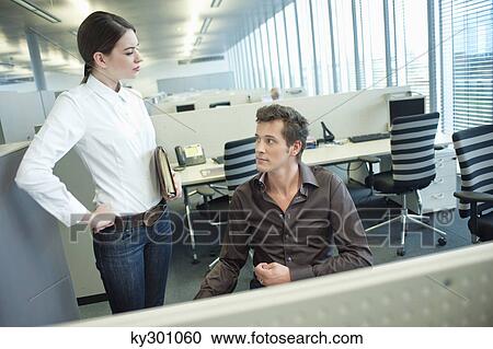 Stock Image - Business executives discussing in an office. Fotosearch