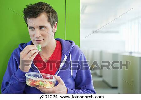 Businessman eating gum drops View Large Photo Image Picture - Businessman eating gum drops. Fotosearch