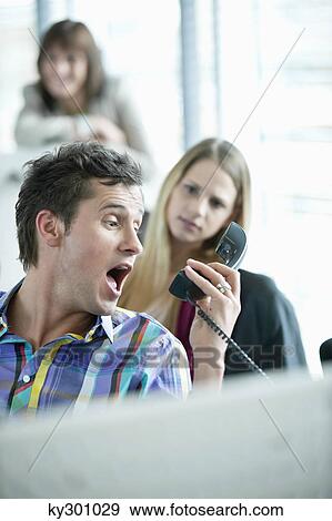 Businessman holding telephone receiver and shouting View Large Photo Image Stock Photo - Businessman holding telephone receiver and shouting. Fotosearch
