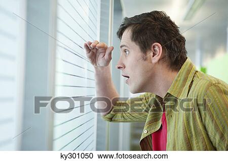 Businessman looking through a window View Large Photo Image Stock Image - Businessman looking through a window. Fotosearch