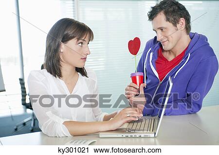 Businessman proposing a businesswoman with a gift View Large Photo Image Stock Image - Businessman proposing a businesswoman with a gift. Fotosearch