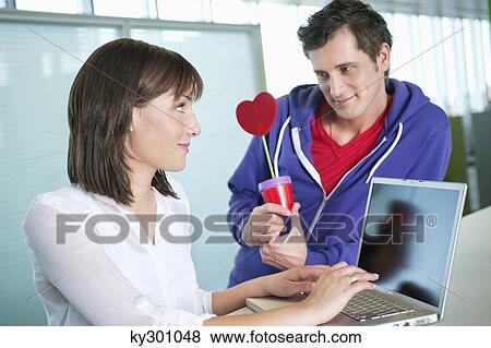 Businessman proposing a businesswoman with a gift View Large Photo Image Stock Photo - Businessman proposing a businesswoman with a gift. Fotosearch