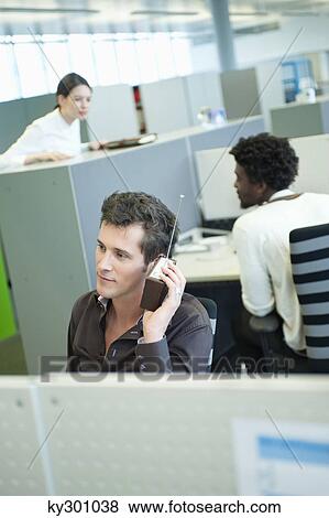 Businessmen listening to a radio in an office View Large Photo Image Stock Photo - Businessmen listening to a radio in an office. Fotosearch