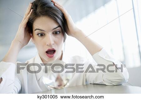 Businesswoman looking at a crystal ball and looking shocked View Large Photo Image Stock Photography - Businesswoman looking at a crystal ball and looking shocked. Fotosearch