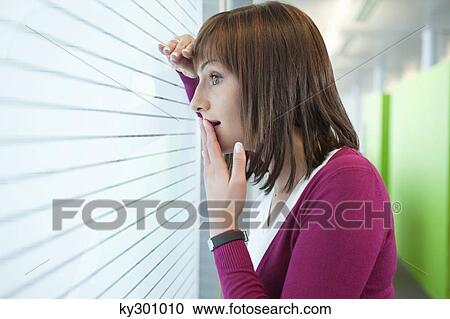Businesswoman looking through a window View Large Photo Image Stock Image - Businesswoman looking through a window. Fotosearch