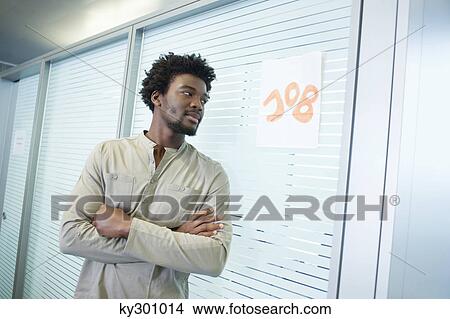 Picture - Male candidate waiting for a job interview outside a cabin. Fotosearch